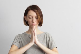 girl-holding-hands-together-elbows-to-the-sides-eyes-closed-6