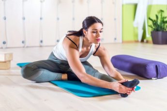 fit-woman-doing-stretching-pilates-exercises-in-fitness-studio
