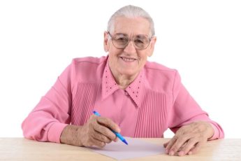elderly-woman-writes-the-document-2